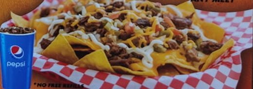 Nachos with meat and cheese in a checkered basket